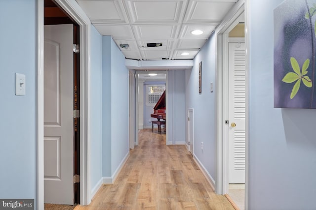 hallway with light hardwood / wood-style floors