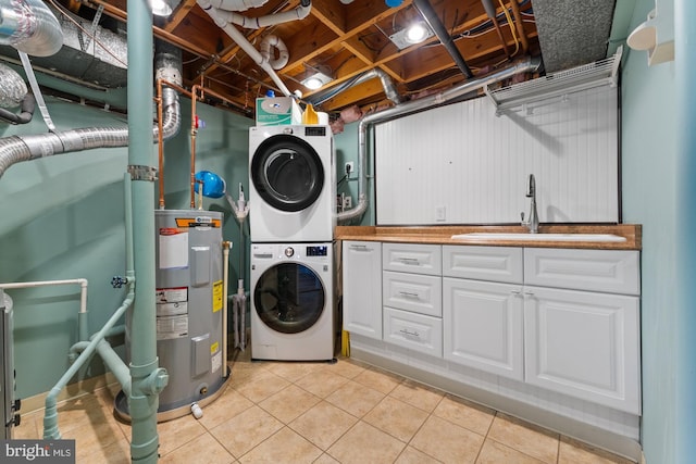 washroom featuring sink, cabinets, light tile patterned floors, electric water heater, and stacked washing maching and dryer