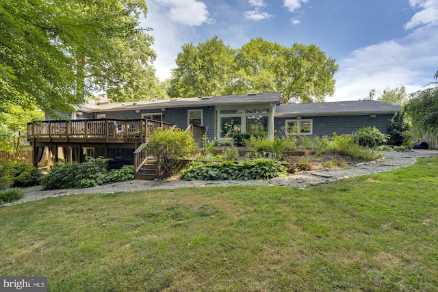 rear view of property with a yard and a deck