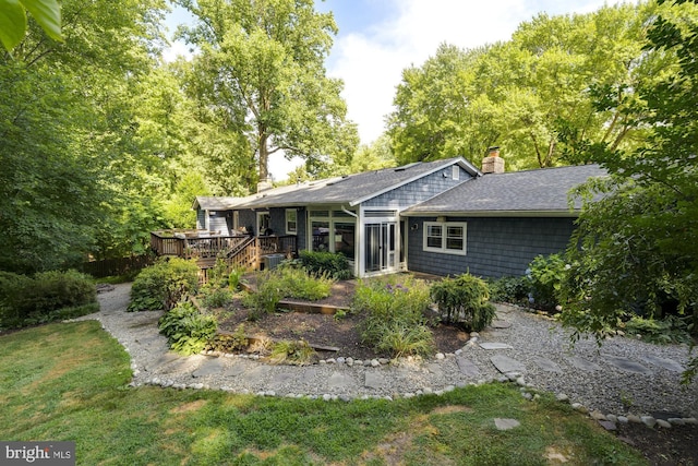 back of house featuring a yard and a deck