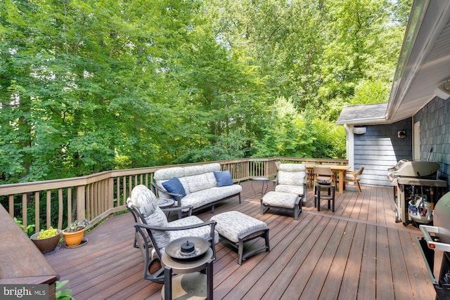 deck with an outdoor living space and a grill