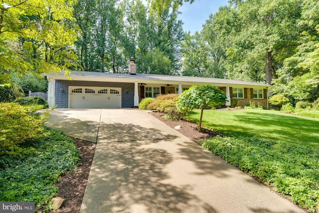 ranch-style house featuring a garage and a front yard