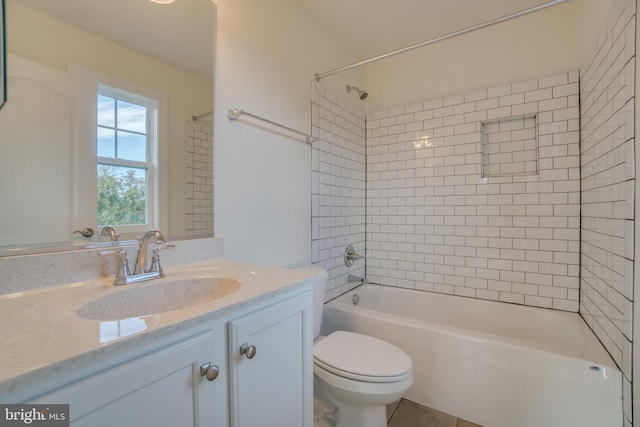 full bathroom featuring vanity, toilet, and tiled shower / bath combo