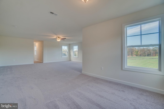 unfurnished room featuring light carpet and ceiling fan