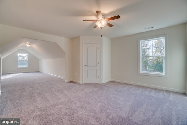 bonus room featuring lofted ceiling, light colored carpet, and ceiling fan