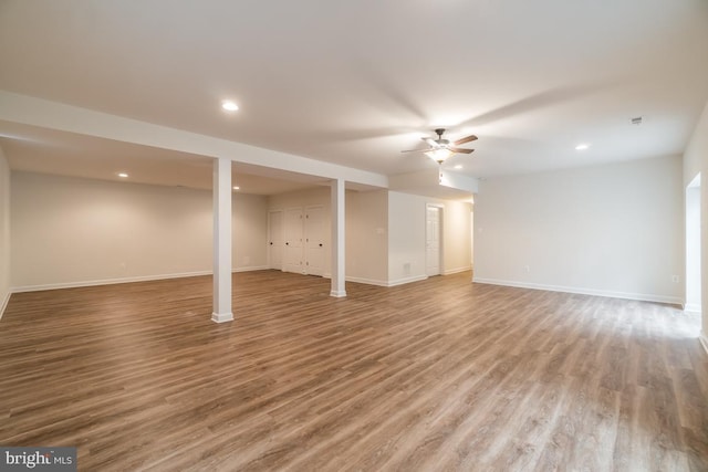 basement with wood-type flooring and ceiling fan