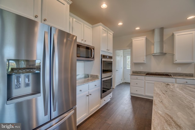 kitchen with white cabinets, stainless steel appliances, and wall chimney range hood