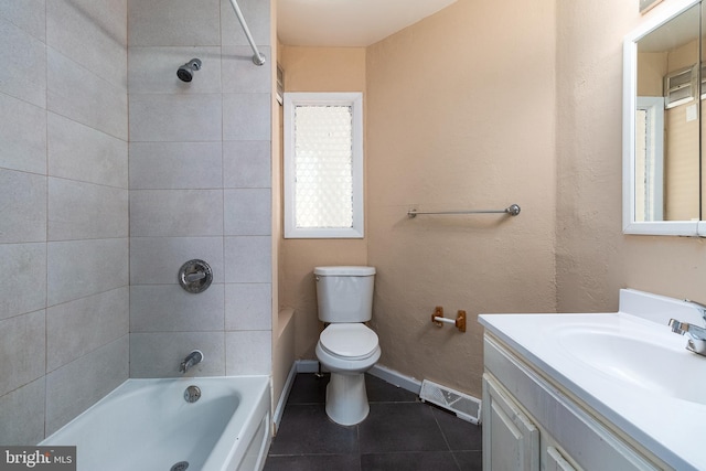 full bathroom featuring tiled shower / bath combo, vanity, tile patterned floors, and toilet