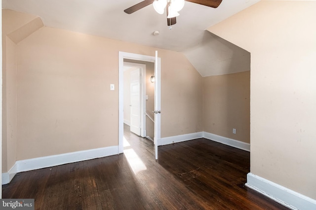 bonus room featuring dark hardwood / wood-style flooring, vaulted ceiling, and ceiling fan