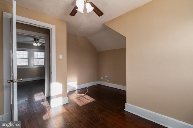 additional living space featuring lofted ceiling, dark hardwood / wood-style floors, a textured ceiling, and ceiling fan