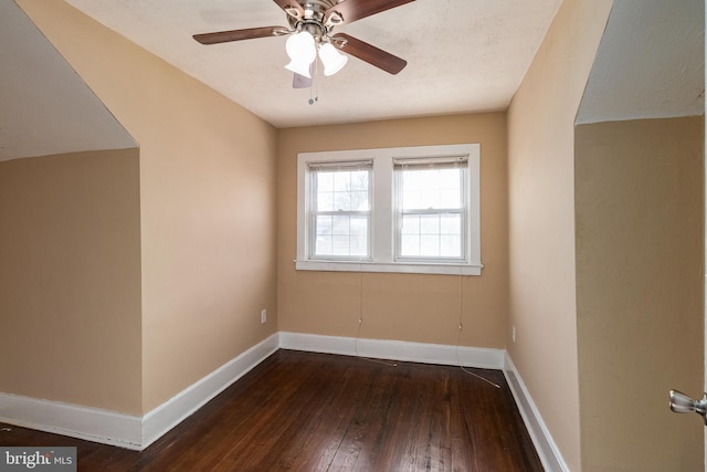 empty room with ceiling fan and dark hardwood / wood-style floors