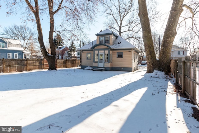 view of snow covered rear of property