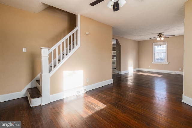 unfurnished living room with ceiling fan and dark hardwood / wood-style flooring