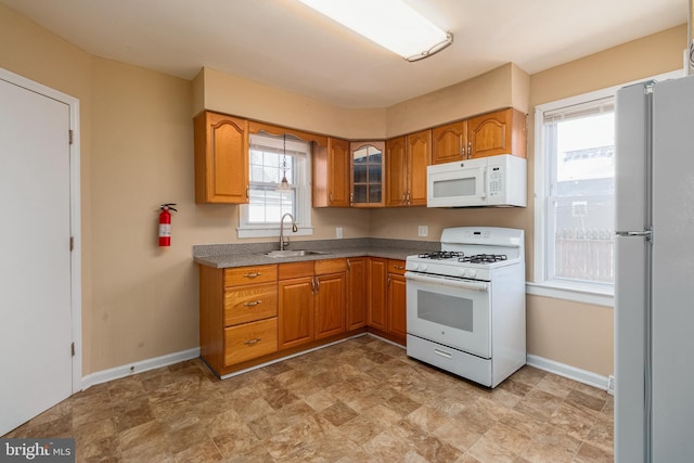 kitchen featuring white appliances and sink