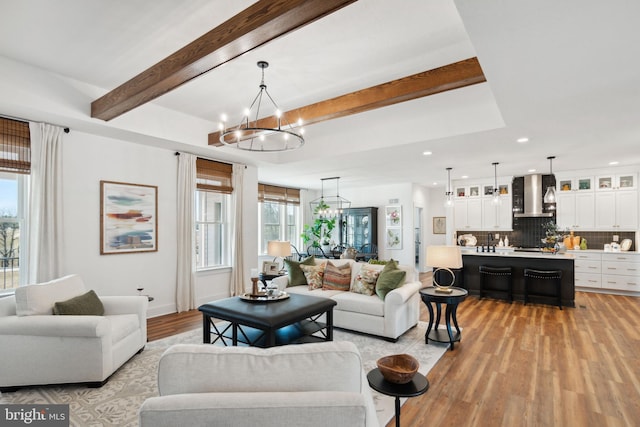 living room featuring an inviting chandelier and light hardwood / wood-style flooring