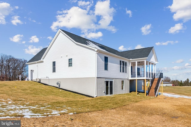 view of side of home with a yard and ceiling fan