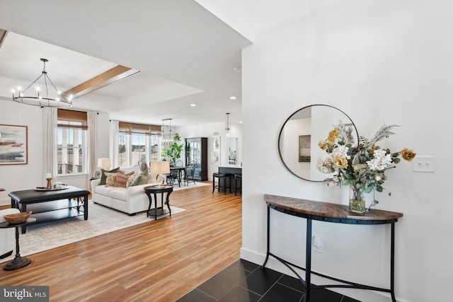 living room featuring wood-type flooring and a notable chandelier