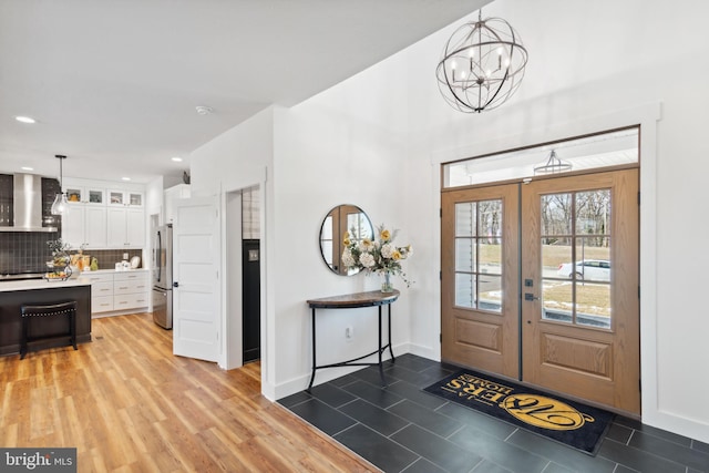 foyer featuring a notable chandelier and french doors