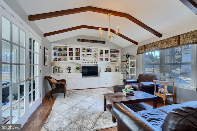 living room featuring hardwood / wood-style flooring, vaulted ceiling with beams, a chandelier, and built in shelves