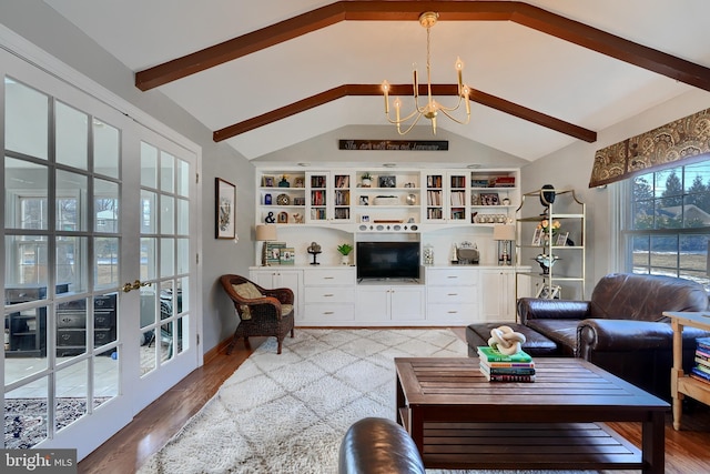 living room featuring lofted ceiling with beams, hardwood / wood-style flooring, and an inviting chandelier