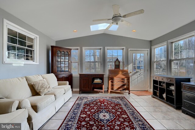 sunroom / solarium featuring lofted ceiling with skylight and ceiling fan