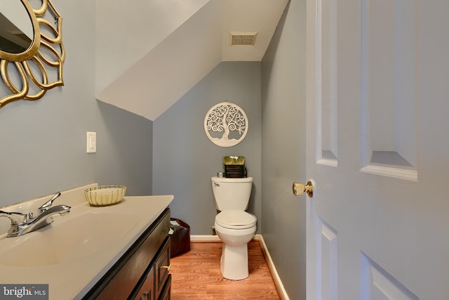 bathroom with vanity, hardwood / wood-style floors, and toilet