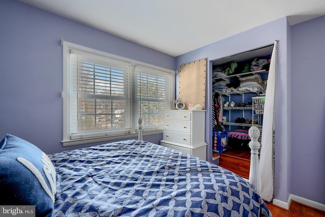 bedroom with hardwood / wood-style floors and a closet