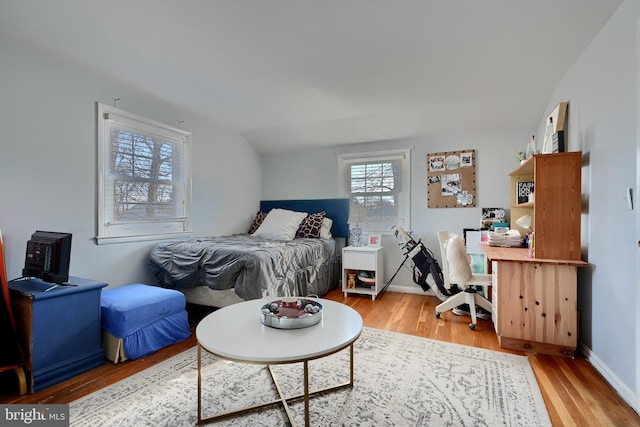 bedroom with hardwood / wood-style flooring and vaulted ceiling