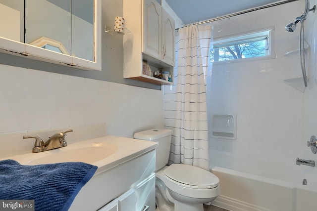 full bathroom with shower / bath combination with curtain, vanity, toilet, and tile walls