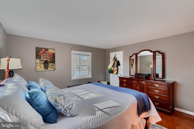 bedroom with dark wood-type flooring and a closet