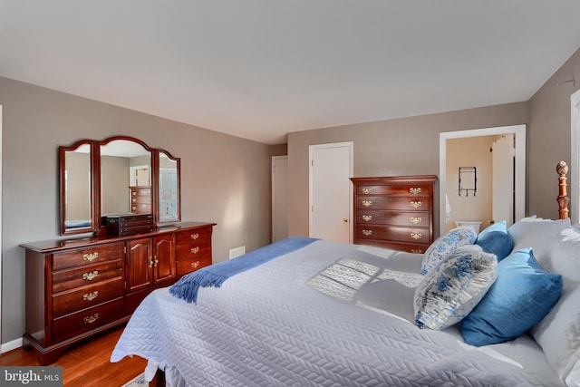 bedroom with hardwood / wood-style flooring