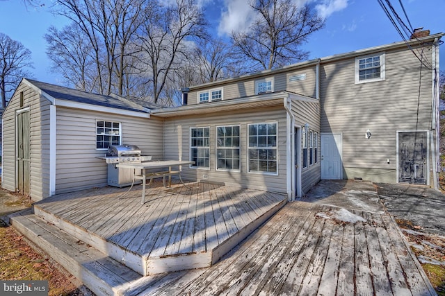 rear view of property featuring a deck