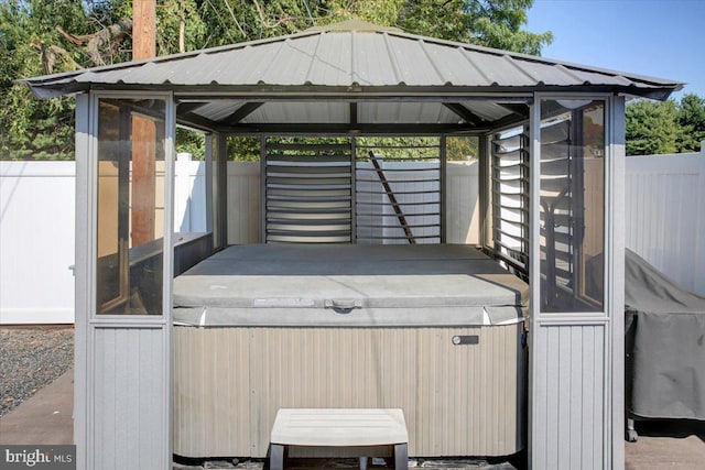 view of patio / terrace featuring a gazebo and a hot tub