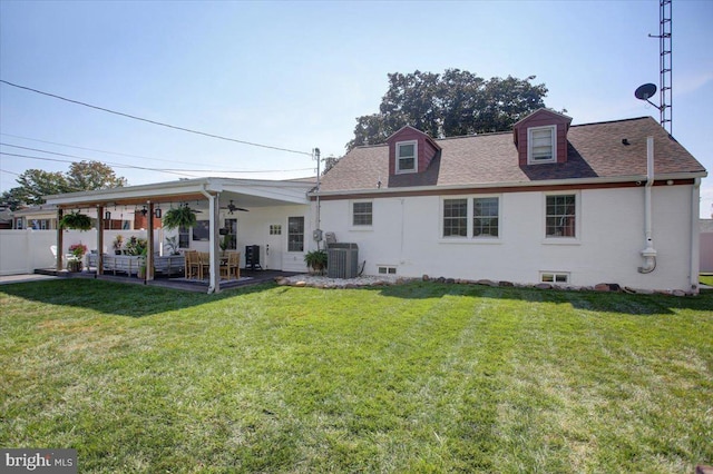 back of property with cooling unit, ceiling fan, a patio, and a lawn