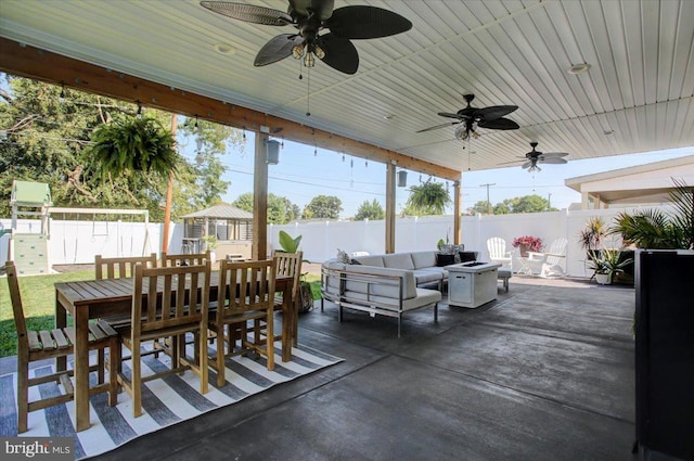 view of patio / terrace with a playground and an outdoor living space with a fire pit