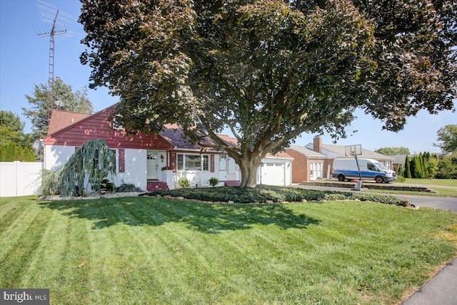 view of front of property with a garage and a front lawn