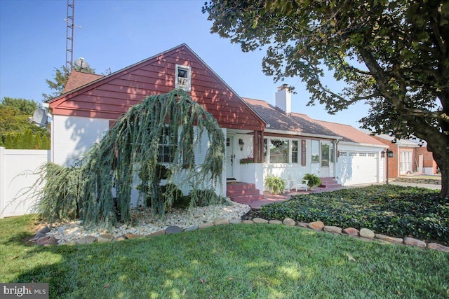 view of front of house with a garage and a front lawn