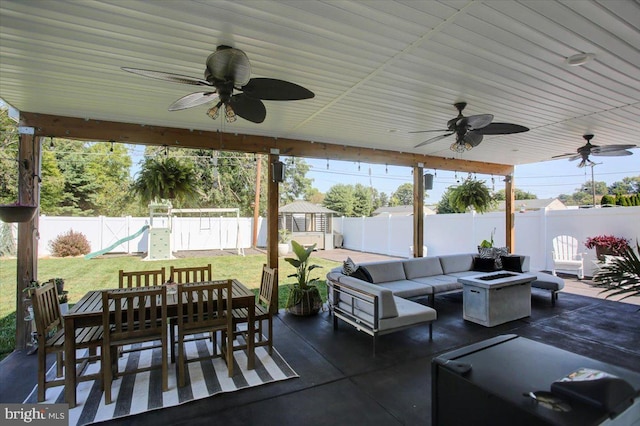 view of patio featuring ceiling fan, outdoor lounge area, and a playground