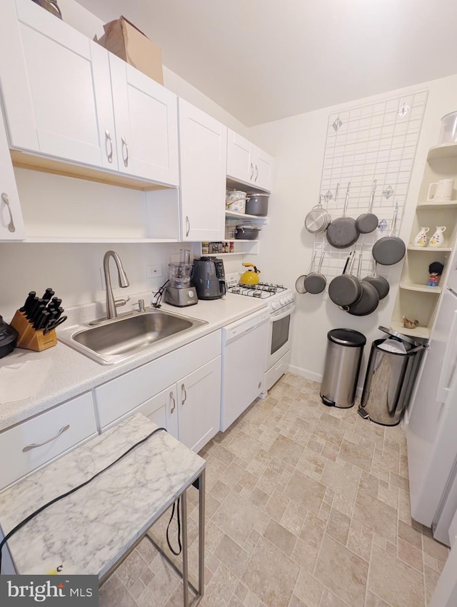 kitchen featuring white cabinetry, white appliances, and sink