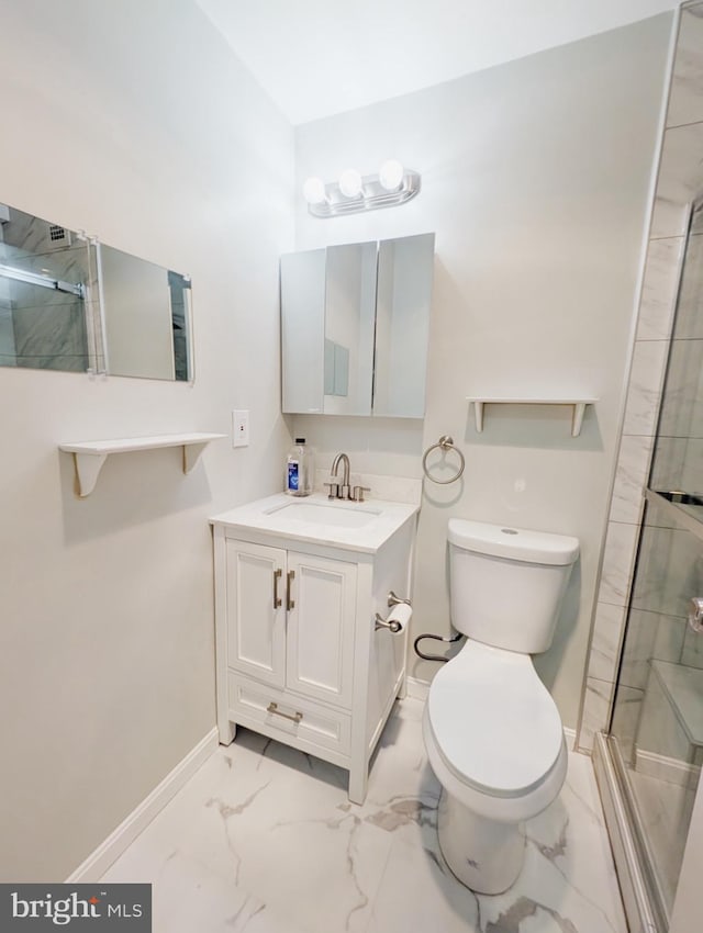 bathroom with vanity, a shower with door, and toilet