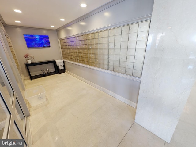 hallway featuring ornamental molding, tile patterned flooring, and a mail area