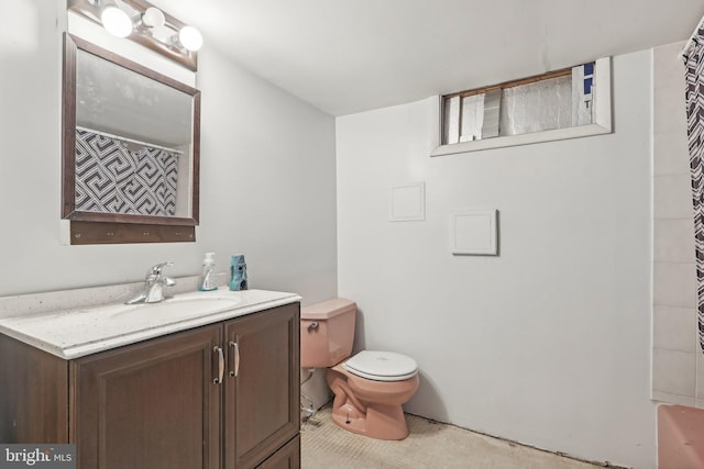 bathroom with vanity, a shower with curtain, and toilet