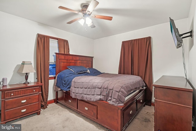 bedroom with light carpet and ceiling fan