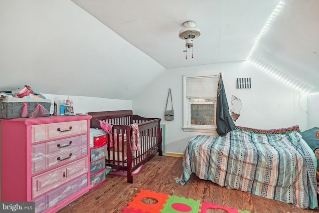 bedroom featuring lofted ceiling, dark hardwood / wood-style floors, and ceiling fan