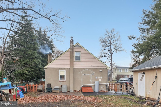 rear view of property with central air condition unit