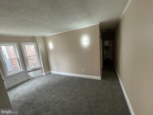 carpeted spare room featuring a textured ceiling, baseboards, and crown molding