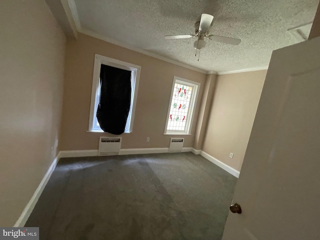 spare room featuring crown molding, a textured ceiling, baseboards, and ceiling fan