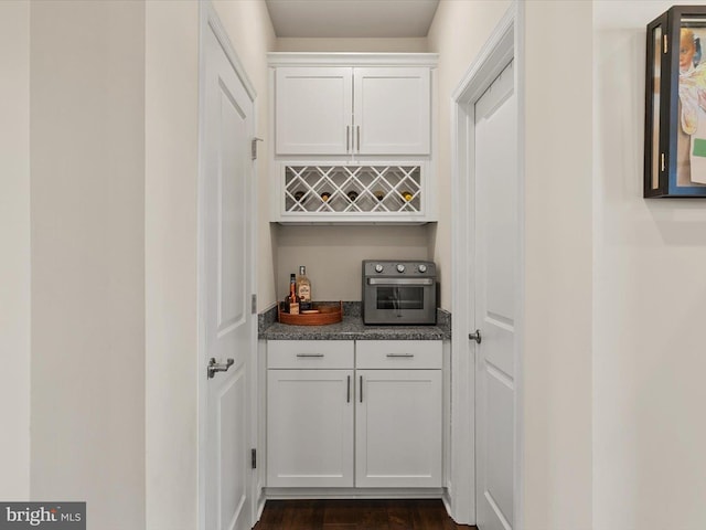 bar featuring white cabinets