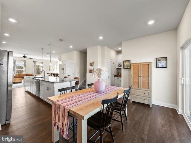 dining area featuring sink and dark hardwood / wood-style flooring