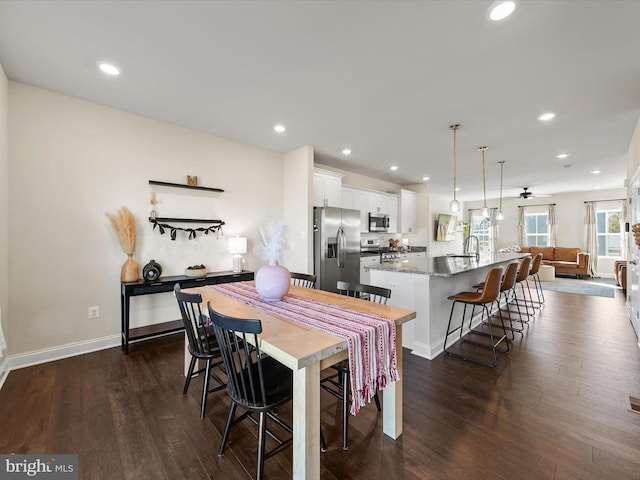 dining area with dark hardwood / wood-style floors and sink